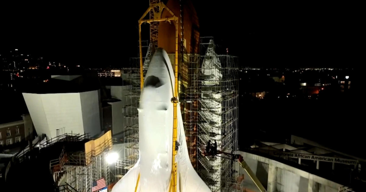 Endeavour, the space shuttle, was lifted into an upright position in preparation for being put on display.