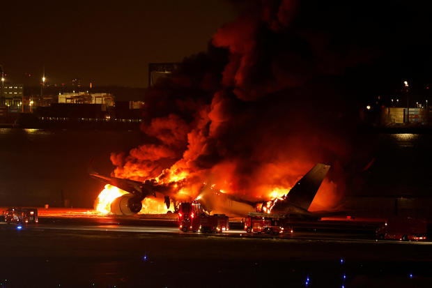 Five people have died and hundreds were forced to leave after a collision between a Japan Airlines plane and a coast guard aircraft at Haneda Airport in Tokyo.