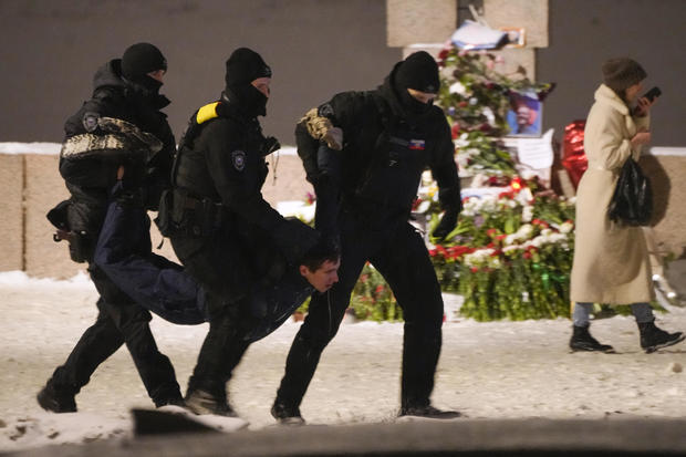 Police officers detain a man laying flowers to Alexey Navalny at the Memorial to Victims of Political Repression in St. Petersburg, Russia, on Feb. 16, 2024. 