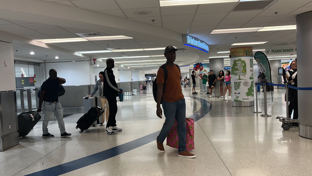 The initial arrival of Americans from Haiti arrives at Miami International Airport in order to flee the turmoil.