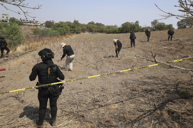 Clandestine burial pits, bones and children's notebooks found in Mexico City, searchers say