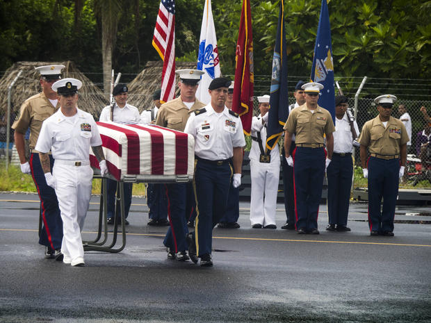 Members of the Defense POW/MIA Accounting Agency carry a transfer case during a repatriation ceremony for service members missing in action from the battle of Tarawa, Republic of Kiribati, July 25, 2017. 