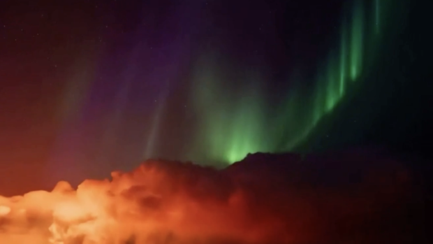 Video shows northern lights dazzle above volcanic eruption in Iceland