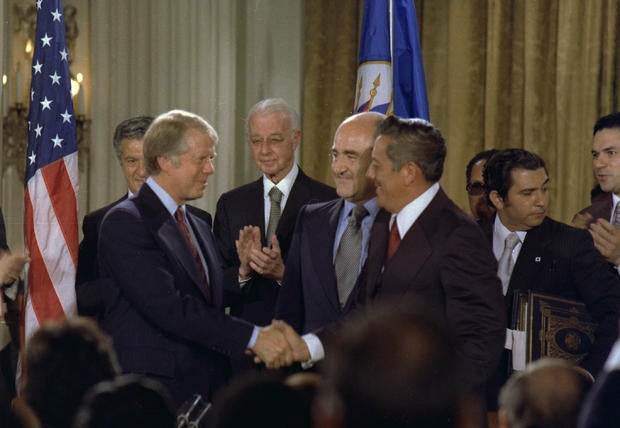 Jimmy Carter and General Omar Torrijos shake hands after signing the Panama Canal Treaty. circa 09/07/1977 