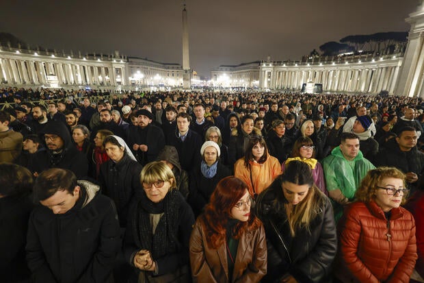 Pope Francis' health unchanged, but he "slept well" as thousands pray in a rainy St. Peter's Square